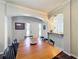 Dining room featuring hardwood floors, an archway, and a large wooden table with chairs at 163 Villa Di Este Ter # 105, Lake Mary, FL 32746