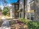 Townhome exterior with low maintenance landscaping and manicured walkway to front door at 163 Villa Di Este Ter # 105, Lake Mary, FL 32746