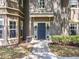 Charming front entrance of the property with lush landscaping, sidewalk and blue door at 163 Villa Di Este Ter # 105, Lake Mary, FL 32746