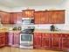 Kitchen with stainless steel appliances, granite countertops, and wooden cabinets at 163 Villa Di Este Ter # 105, Lake Mary, FL 32746