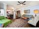 Spacious living room featuring elegant crown molding, a ceiling fan, and an open floor plan to the kitchen and dining area at 163 Villa Di Este Ter # 105, Lake Mary, FL 32746