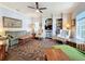 Living room featuring hard wood floors, built in book shelves, and a ceiling fan at 163 Villa Di Este Ter # 105, Lake Mary, FL 32746