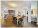 Open living space featuring hardwood floors, dining table, living room, and built in bookshelves at 163 Villa Di Este Ter # 105, Lake Mary, FL 32746