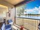 Screened lanai features stunning lake views, lounge seating, and relaxing ambiance at 163 Villa Di Este Ter # 105, Lake Mary, FL 32746