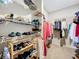 Well-organized walk-in closet with ample shelving, rods, and space for shoes, bags, and other items at 163 Villa Di Este Ter # 105, Lake Mary, FL 32746