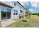 Landscaped backyard with well-maintained lawn, young trees, patio, and privacy fence at 16391 Bird Of Paradise Ave, Clermont, FL 34714