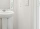 Clean, modern bathroom with pedestal sink and contemporary fixtures at 16391 Bird Of Paradise Ave, Clermont, FL 34714