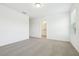 Large carpeted bedroom with an adjoining bathroom at 16391 Bird Of Paradise Ave, Clermont, FL 34714