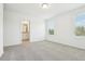 Bright bedroom with neutral carpet, two large windows, and adjoining bathroom at 16391 Bird Of Paradise Ave, Clermont, FL 34714