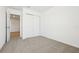 Large carpeted bedroom featuring a closet and connecting door to other rooms at 16391 Bird Of Paradise Ave, Clermont, FL 34714