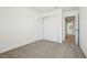 Bedroom showing neutral carpet, closet, and connecting door to other rooms at 16391 Bird Of Paradise Ave, Clermont, FL 34714