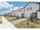 Row of modern townhomes with manicured landscaping, brick driveways, and ample parking in a desirable neighborhood at 16391 Bird Of Paradise Ave, Clermont, FL 34714