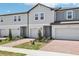 Inviting townhomes featuring brick driveways, attached garages, and fresh landscaping for a welcoming curb appeal at 16391 Bird Of Paradise Ave, Clermont, FL 34714