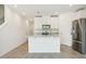 Modern kitchen showcasing white cabinets, stainless steel appliances, and a central island for cooking and gathering at 16391 Bird Of Paradise Ave, Clermont, FL 34714
