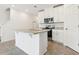 Contemporary kitchen featuring white cabinetry, stainless steel appliances, and a center island with seating options at 16391 Bird Of Paradise Ave, Clermont, FL 34714