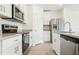 Stylish kitchen with white cabinets, granite countertops, and stainless steel appliances for a modern cooking experience at 16391 Bird Of Paradise Ave, Clermont, FL 34714