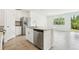 Bright kitchen featuring white cabinets, stainless steel appliances, and an island perfect for meal prep and entertaining at 16391 Bird Of Paradise Ave, Clermont, FL 34714