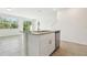 Open kitchen with a center island, stainless steel appliances, and adjacent living area, perfect for modern living at 16391 Bird Of Paradise Ave, Clermont, FL 34714