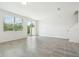 Spacious living room with tile flooring, natural light, and sliding door access to the backyard at 16391 Bird Of Paradise Ave, Clermont, FL 34714