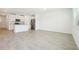 Open-concept living area featuring tile floors and a modern kitchen with stainless steel appliances at 16391 Bird Of Paradise Ave, Clermont, FL 34714