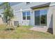 A backyard features a sliding door, AC unit, and a small tree on a sunny day at 16399 Bird Of Paradise Ave, Clermont, FL 34714