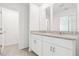 Bathroom featuring double sinks, granite countertops, and sleek fixtures at 16399 Bird Of Paradise Ave, Clermont, FL 34714