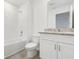 Bright bathroom with granite countertop and tiled shower/tub at 16399 Bird Of Paradise Ave, Clermont, FL 34714