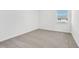 Well-lit bedroom featuring neutral carpet and a window at 16399 Bird Of Paradise Ave, Clermont, FL 34714