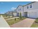 Wide angle exterior view of the neighborhood townhomes with brick driveways at 16399 Bird Of Paradise Ave, Clermont, FL 34714