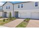 Close-up view of townhomes with brick driveways and well-manicured landscaping at 16399 Bird Of Paradise Ave, Clermont, FL 34714