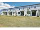 A row of new townhomes with well-kept lawns offers a modern and inviting curb appeal at 16399 Bird Of Paradise Ave, Clermont, FL 34714