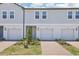 Charming townhome exterior features attached garages, brick driveways and walkways, and professionally landscaped lawns at 16399 Bird Of Paradise Ave, Clermont, FL 34714