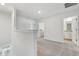 Hallway with carpeted floors leading to bathroom and laundry room at 16399 Bird Of Paradise Ave, Clermont, FL 34714