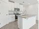 Bright kitchen features stainless steel appliances, granite countertops, and white cabinets at 16399 Bird Of Paradise Ave, Clermont, FL 34714