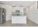 Spacious kitchen with stainless steel appliances, granite countertops, and ample cabinet space at 16399 Bird Of Paradise Ave, Clermont, FL 34714