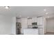 Bright kitchen with white cabinetry, granite countertops, and stainless steel appliances at 16399 Bird Of Paradise Ave, Clermont, FL 34714