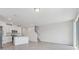 Open-concept kitchen flowing into living area, with white cabinetry and granite countertops at 16399 Bird Of Paradise Ave, Clermont, FL 34714