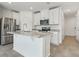 Modern kitchen features a large island, stainless steel appliances, and granite countertops at 16399 Bird Of Paradise Ave, Clermont, FL 34714