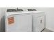 A Whirlpool washer and dryer in a well-lit laundry area offers convenience for everyday chores at 16399 Bird Of Paradise Ave, Clermont, FL 34714