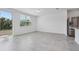 Bright and airy living room featuring tile floors, large windows, and access to the backyard at 16399 Bird Of Paradise Ave, Clermont, FL 34714