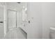 Well-lit bathroom offers a glass shower, a single sink vanity, and neutral tile flooring at 16466 Bird Of Paradise Ave, Clermont, FL 34714