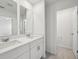 Bright bathroom featuring a double vanity with a white countertop and modern fixtures at 16466 Bird Of Paradise Ave, Clermont, FL 34714