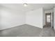 Clean bedroom with a doorway to other rooms, neutral carpet, and white walls at 16466 Bird Of Paradise Ave, Clermont, FL 34714