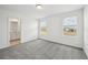 Bedroom with dual windows offering backyard views, paired with neutral carpet for comfort at 16466 Bird Of Paradise Ave, Clermont, FL 34714