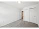 Bedroom with a closet showcasing its neutral carpet and door leading to other rooms at 16466 Bird Of Paradise Ave, Clermont, FL 34714