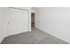 Neutral-carpeted bedroom with closet, and doorway that leads to other rooms in the home at 16466 Bird Of Paradise Ave, Clermont, FL 34714