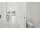 Bright hallway with light tile flooring, connecting the living spaces and powder room at 16466 Bird Of Paradise Ave, Clermont, FL 34714