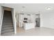 Bright kitchen with white cabinets, a large island, stainless steel appliances, and tiled flooring at 16466 Bird Of Paradise Ave, Clermont, FL 34714