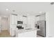 Modern kitchen featuring white cabinets, stainless steel appliances, and an island at 16466 Bird Of Paradise Ave, Clermont, FL 34714