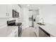 Modern kitchen featuring white cabinetry, stainless steel appliances, and light countertops at 16466 Bird Of Paradise Ave, Clermont, FL 34714